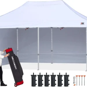 White event canopy with side walls; a woman handles an ABCCANOPY carrying bag, with weight bags and stakes arranged in front.